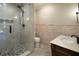 Bathroom with a frameless shower, pebble floor, and designer tile at 858 Middle Fork Trl, Suwanee, GA 30024