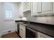 Wet bar with granite countertops and wine rack at 858 Middle Fork Trl, Suwanee, GA 30024