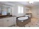 Elegant bathroom with double vanities, soaking tub, and walk-in shower at 858 Middle Fork Trl, Suwanee, GA 30024