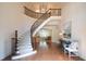 Elegant two-story staircase with wrought iron railing and chandelier at 858 Middle Fork Trl, Suwanee, GA 30024
