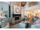 Spacious living room features a stone fireplace and large windows at 858 Middle Fork Trl, Suwanee, GA 30024