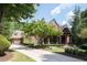 Brick house with a large front porch and landscaping at 858 Middle Fork Trl, Suwanee, GA 30024