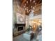 Two-story living room with a stone fireplace and chandelier at 858 Middle Fork Trl, Suwanee, GA 30024