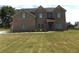 Two-story brick house with gray shutters, a three-car garage, and a spacious front yard at 689 S Jeff Davis Dr, Fayetteville, GA 30215
