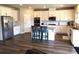 Modern kitchen with white cabinets, granite countertops, stainless steel appliances, and hardwood floors at 689 S Jeff Davis Dr, Fayetteville, GA 30215