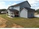 Two-story home with a covered patio, detached garage, and a large backyard at 689 S Jeff Davis Dr, Fayetteville, GA 30215