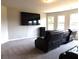 Spacious bonus room with large TV, carpeted floors, and comfortable seating at 689 S Jeff Davis Dr, Fayetteville, GA 30215