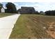 Two-story house with a long driveway, attached garage, and a large lot at 689 S Jeff Davis Dr, Fayetteville, GA 30215