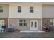Townhouse back patio with small yard, concrete patio, and grill at 174 Hampton Cir, Mcdonough, GA 30253