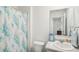 Clean bathroom with a shower/tub combo and floral curtain at 174 Hampton Cir, Mcdonough, GA 30253