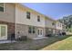 Row of townhouses showcasing back patios and a shared grassy area at 174 Hampton Cir, Mcdonough, GA 30253