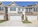 Two-story townhome with attached garage and landscaping at 174 Hampton Cir, Mcdonough, GA 30253