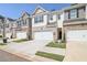 Row of townhouses with attached garages and landscaping at 174 Hampton Cir, Mcdonough, GA 30253