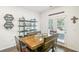 Bright dining area with wood table and chairs, built-in shelving, and access to backyard at 174 Hampton Cir, Mcdonough, GA 30253