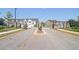 Gated community entrance with a paved road and landscaping at 174 Hampton Cir, Mcdonough, GA 30253