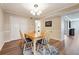 Bright dining room features wood flooring, a table with four chairs, and an area rug at 6851 Roswell Rd # E1, Atlanta, GA 30328