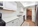 Updated kitchen with white cabinets, stainless steel appliances, and a dining area view at 6851 Roswell Rd # E1, Atlanta, GA 30328