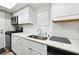 Updated kitchen, white shaker cabinets, quartz countertops, and stainless steel appliances at 6851 Roswell Rd # E1, Atlanta, GA 30328