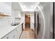 Modern kitchen with white cabinets, stainless steel appliances, and a view to the dining area at 6851 Roswell Rd # E1, Atlanta, GA 30328