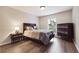 Cozy bedroom with wood flooring, a double bed, nightstand, and dresser at 6851 Roswell Rd # E1, Atlanta, GA 30328
