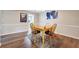 A well-lit dining area with hardwood floors and a charming wooden dining set at 6851 Roswell Rd # E1, Atlanta, GA 30328