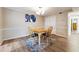 Bright dining room with hardwood floors, a wooden table and chairs, and wall art at 6851 Roswell Rd # E1, Atlanta, GA 30328