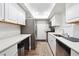 Modern kitchen with white cabinets, quartz countertops, and stainless steel appliances at 6851 Roswell Rd # E1, Atlanta, GA 30328