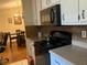 Efficient kitchen with black appliances and light cabinetry at 4489 Iroquois Trl, Duluth, GA 30096