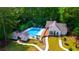 Aerial view of community pool, clubhouse, and surrounding landscape at 1094 Battery Park Rd, Decatur, GA 30033