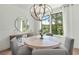 Bright dining room with a round table, gray chairs, and large windows at 1094 Battery Park Rd, Decatur, GA 30033