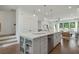 Open concept kitchen with island, stainless steel appliances, and hardwood floors at 1096 Battery Park Rd, Decatur, GA 30033