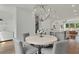 Elegant dining area with round table and gray chairs, open to kitchen at 1096 Battery Park Rd, Decatur, GA 30033