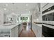 Open concept kitchen boasting stainless steel appliances and hardwood floors at 1096 Battery Park Rd, Decatur, GA 30033