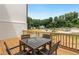 Deck with table and chairs, offering a view of the surrounding neighborhood at 1096 Battery Park Rd, Decatur, GA 30033