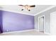 Spacious bedroom with lavender walls, ceiling fan, and plush carpeting at 4079 Dinmont Chase, South Fulton, GA 30349