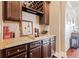 Wet bar with granite countertop, wine rack, and ample cabinet storage at 4079 Dinmont Chase, South Fulton, GA 30349