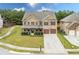 Two-story brick home with attached two-car garage and landscaped yard at 4079 Dinmont Chase, South Fulton, GA 30349