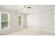 Well-lit bedroom with neutral decor and two windows at 2049 Town Square Dr, Mcdonough, GA 30253