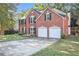 Brick house with a two-car garage and landscaping at 2049 Town Square Dr, Mcdonough, GA 30253