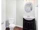 Clean bathroom with dark vanity, tile floor, and oval mirror at 2049 Town Square Dr, Mcdonough, GA 30253
