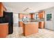 Spacious kitchen with an island, wood cabinets, and tile flooring at 2049 Town Square Dr, Mcdonough, GA 30253