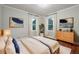 Spacious primary bedroom with hardwood floors, large windows, and plenty of natural light at 187 Main Nw St, Lilburn, GA 30047