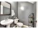 Small bathroom with pedestal sink, toilet, and decorative shelf at 1798 Willow Branch Nw Ln # F, Kennesaw, GA 30152