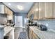 Modern kitchen with granite counters, stainless steel appliances and wood cabinets at 1798 Willow Branch Nw Ln # F, Kennesaw, GA 30152