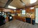 Rustic kitchen with wood cabinets, modern appliances, and laminate flooring at 268 Arnold Mill Rd, Woodstock, GA 30188