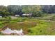 Farm pond with surrounding greenery and farm equipment nearby at 268 Arnold Mill Rd, Woodstock, GA 30188
