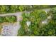 Aerial view showing a house nestled in a wooded area, with a road and other buildings nearby at 268 Arnold Mill Rd, Woodstock, GA 30188