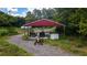 Red metal-roofed workshop with tractors and equipment at 268 Arnold Mill Rd, Woodstock, GA 30188
