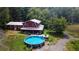 Aerial view of a red house with a pool and surrounding green space at 268 Arnold Mill Rd, Woodstock, GA 30188