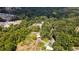 Aerial view showing property with house, pool and large wooded area at 268 Arnold Mill Rd, Woodstock, GA 30188